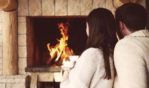 Couple in front of warm fire
