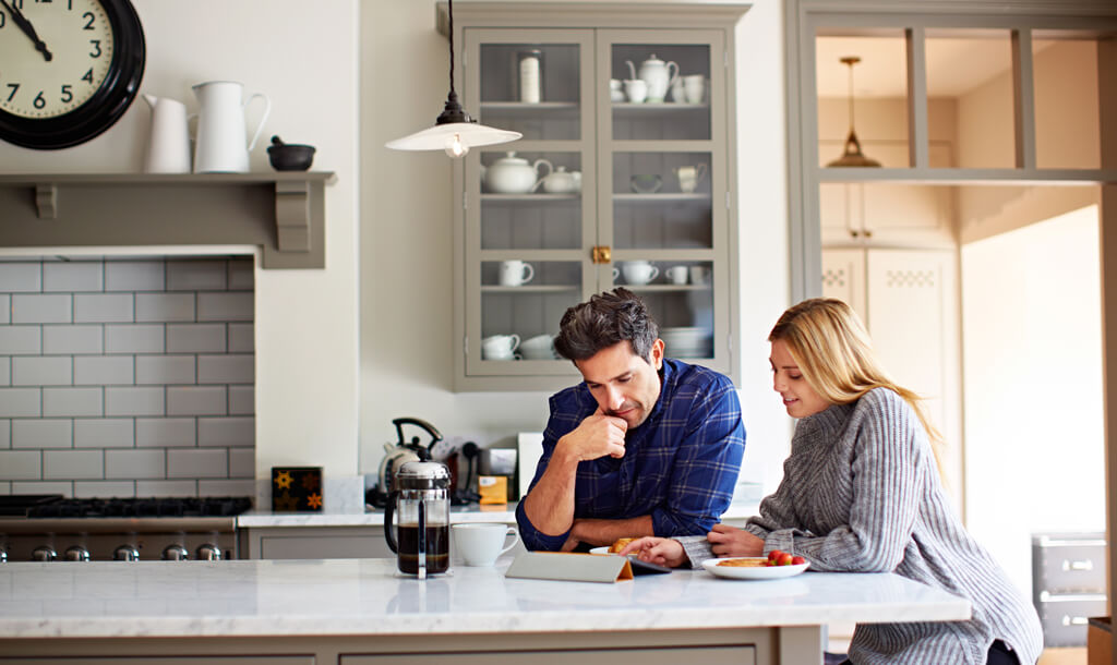 Man and woman sitting in their kitchen
